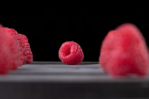Raspberry on a dark wooden background Stock Photos