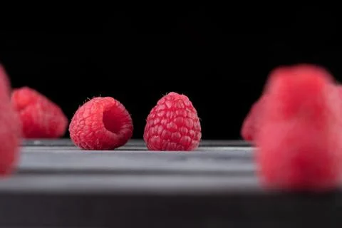 Raspberry on a dark wooden background Stock Photos