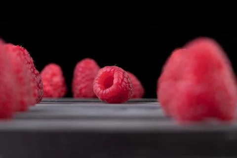 Raspberry on a dark wooden background Stock Photos