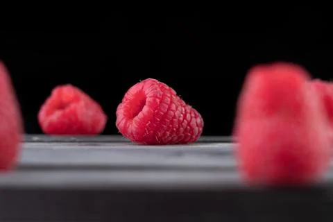 Raspberry on a dark wooden background Stock Photos