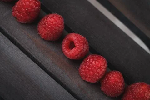 Raspberry on a dark wooden background Stock Photos