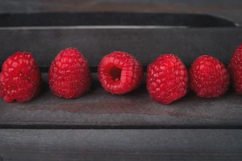 Raspberry on a dark wooden background Stock Photos
