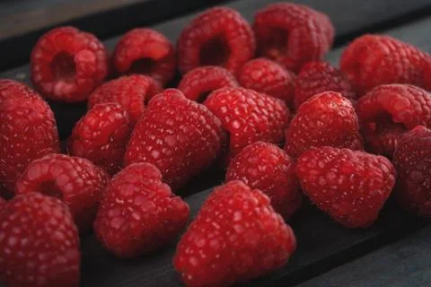 Raspberry on a dark wooden background Stock Photos