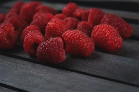 Raspberry on a dark wooden background Stock Photos