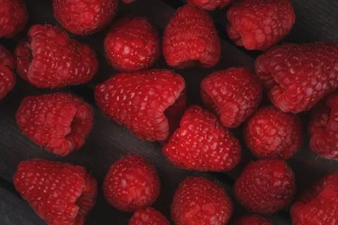 Raspberry on a dark wooden background Stock Photos