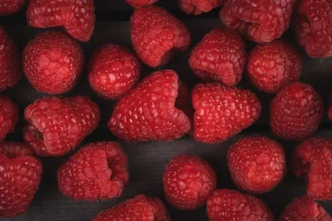 Raspberry on a dark wooden background Stock Photos
