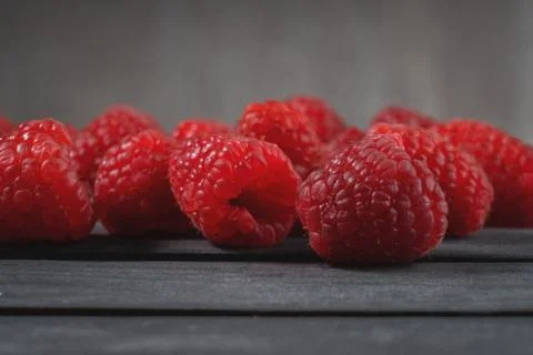 Raspberry on a dark wooden background Stock Photos
