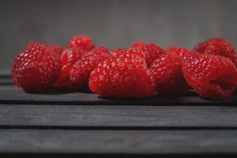 Raspberry on a dark wooden background Stock Photos