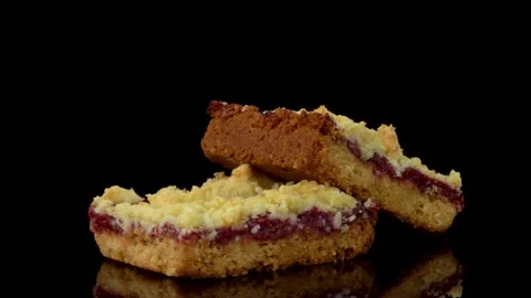 Raspberry Dessert Squares Rotating on Reflective Surface on Dark Background Stock Footage 330517478