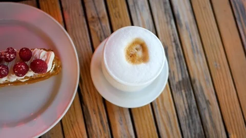 Raspberry dessert on a white plate and latte Video stock 100034536