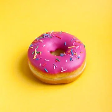 Raspberry donut with icing on a yellow background. Top view. Minimal concept Stock Photos