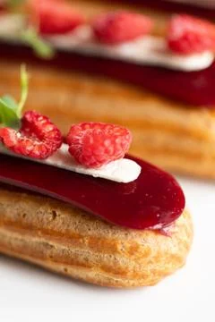 Raspberry Eclair on white background Stock Photos