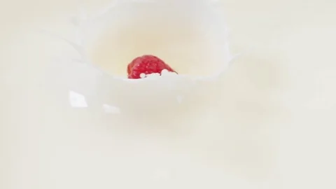 Raspberry falling into milk Video stock 85075127