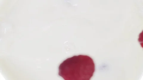 Raspberry falling into milk Stock Footage 85075145