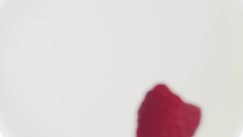 Raspberry falling into milk Stock Footage 85075184