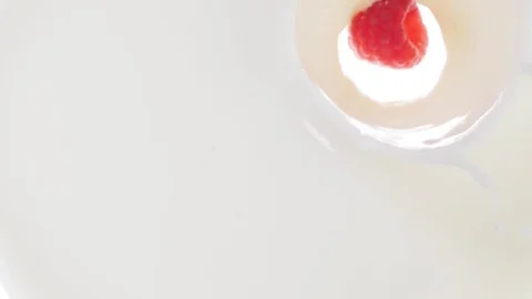 Raspberry falling into milk Stock Footage 85075293