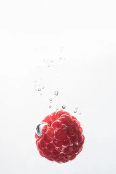Raspberry falling into a water Stock Photos