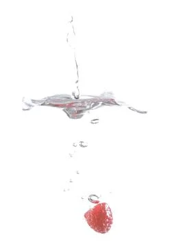 Raspberry falls deeply under water with a big splash. Stock Photos