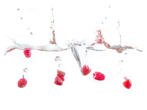 Raspberry falls deeply under water with a big splash. Stock Photos