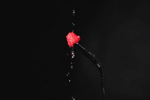 Raspberry on a fork. Freeze motion splash water Stock-Fotos