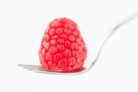 A raspberry on a fork Stock Photos