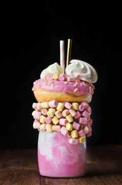 Raspberry freak shake on rustic wooden table over black background Stock Photos