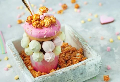 Raspberry freak shake topping with donut in the white wooden box Stock Photos