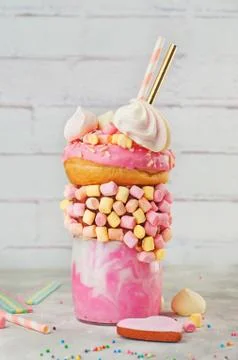 Raspberry freak shake topping with donut on grey background Stock Photos