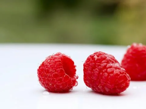 Raspberry fruit lying on wood. Closeup macro Stock Photos