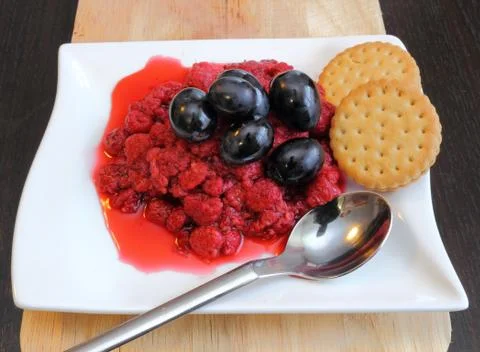 Raspberry with grapes and biscuits 스톡 사진