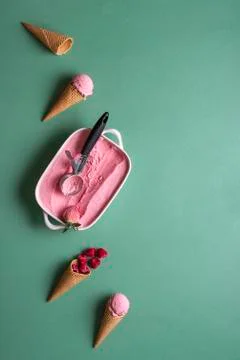 Raspberry ice and waffle cones on green table. Homemade ice cream Stock Photos