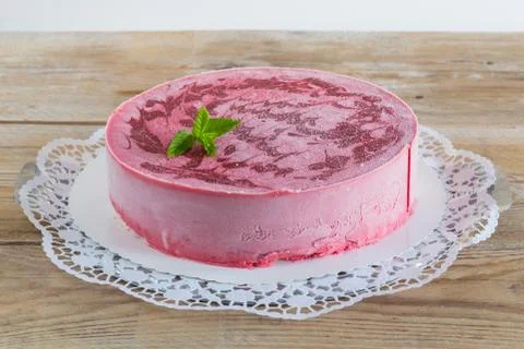 Raspberry ice cream cake on raw wood rustic Stock Photos