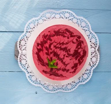 Raspberry ice cream cake on rustic blue wood Stock Photos