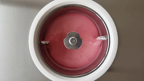Raspberry Ice Cream Churning in Ice Cream Machie 1 4K Stock Footage 78066409