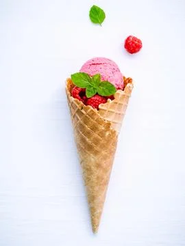 Raspberry ice cream in cone with fresh raspberry and peppermint leaves setu.. Stock Photos
