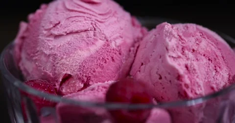 Raspberry ice cream in a glass bowl on a black background, delicious sweet cold Stock Footage 299568949