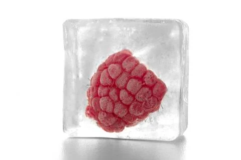 Raspberry in ice cube Stock Photos