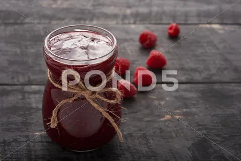 Raspberry jam and berries on the table Stock Photos