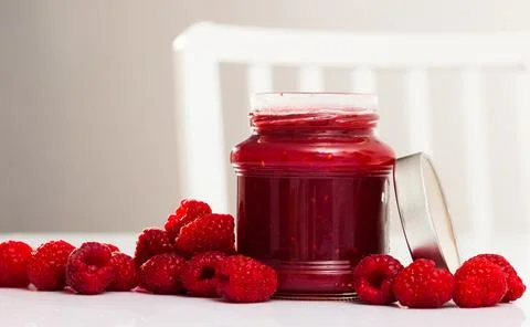 Raspberry jam and fresh raspberries Stock Photos