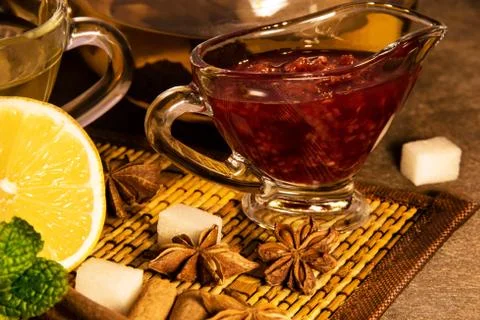 Raspberry jam and Lemon Tea in transparent mug mint and , ginger cinnamo brew Stock Photos