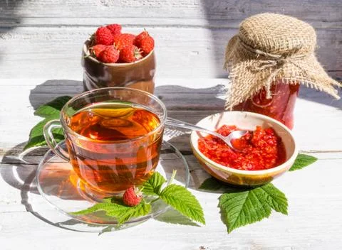 Raspberry jam and tea in cup Stock Photos