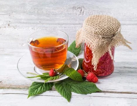 Raspberry jam and tea in cup Stock Photos
