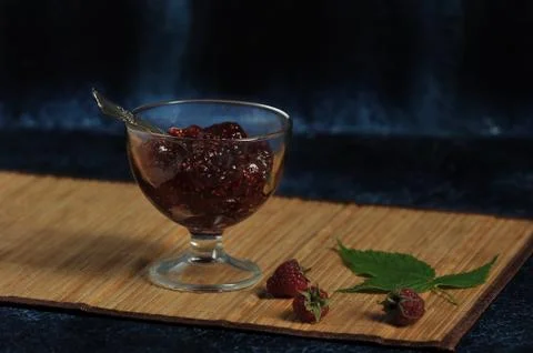 Raspberry jam on bamboo background Stock Photos