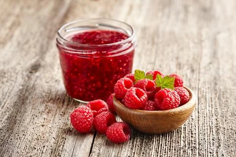 Raspberry jam with berry on wooden background Stock Photos