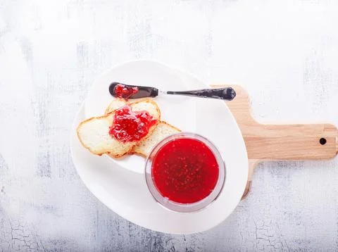 Raspberry jam in bowl with toast Stock Photos