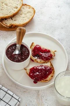 Raspberry jam on bread on a plate Stock Photos