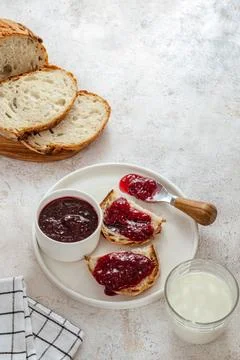 Raspberry jam on bread on a plate Stock Photos