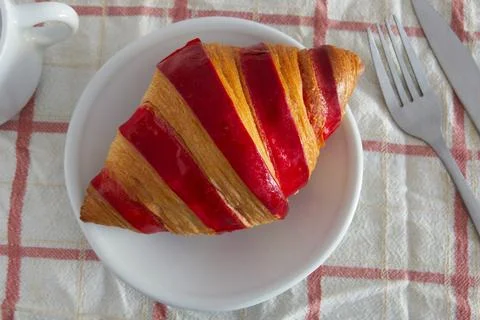 Raspberry jam croissant on a plate Stock Photos