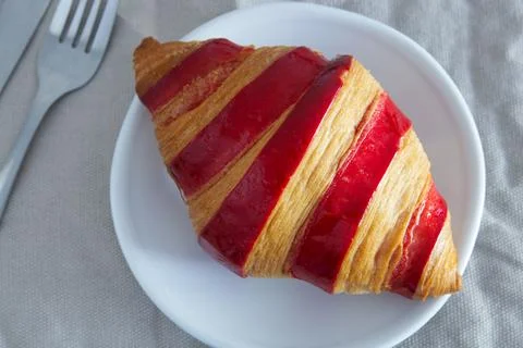 Raspberry jam croissant on a plate Stock Photos