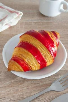 Raspberry jam croissant on a plate Stock Photos